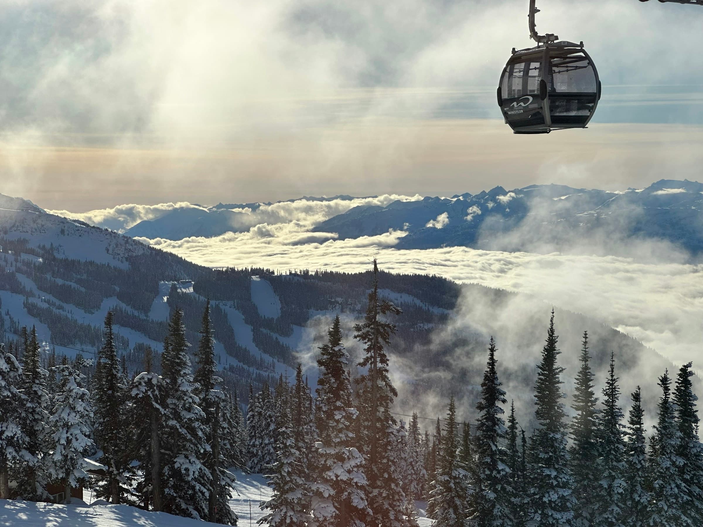 A gondola cabin above valley cloud at Whistler Blackcomb